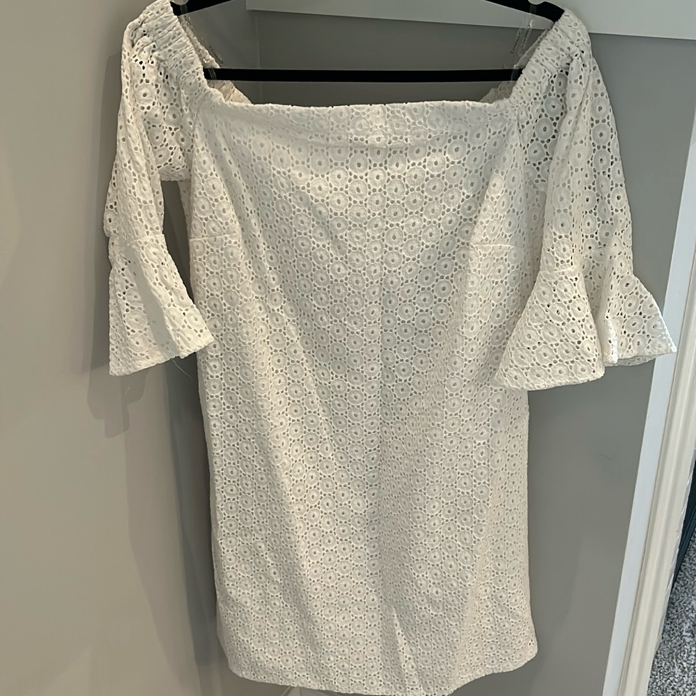 White eyelet dress. Wide neck. Knee length